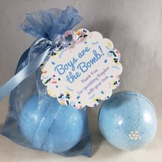 a blue bath bomb with a tag on it sitting next to an egg in a bag