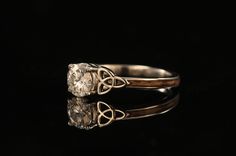 an antique diamond ring on a black background