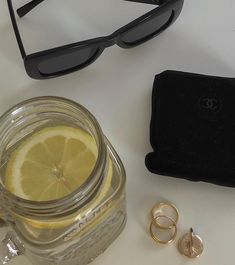 a pair of glasses, ring and lemon slice on a table