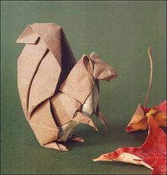 an origami mouse is standing on its hind legs