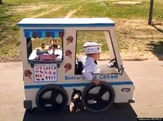 a small ice cream truck is parked on the side of the road