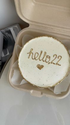 a cake in a box with the word hello 22 written on it and a heart