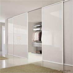 an empty room with white walls and sliding glass doors