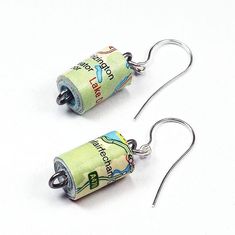 pair of earrings made out of rolled up money