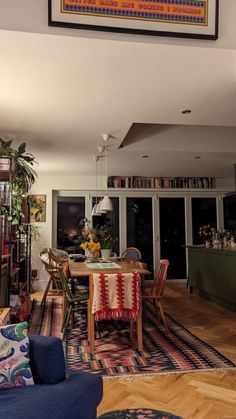 a living room filled with furniture and a painting on the wall