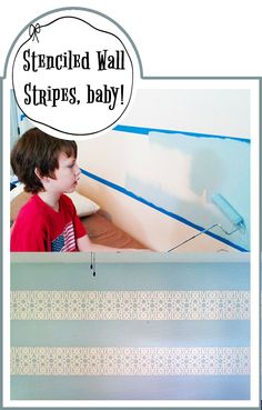 a boy is sitting in front of a wall with blue tape on it and the words stenciled wall strips, baby above him