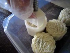 some kind of food that is being made on a cutting board with plastic wrappers