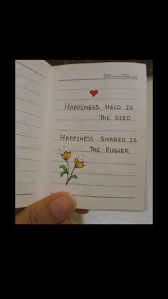 someone is holding up a book with writing on it that says happiness, the seed