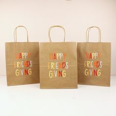 three brown shopping bags with happy friends giving written on them