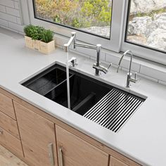 a kitchen sink with two faucets in front of a window