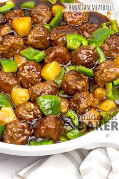 meatballs and peppers are in a white bowl