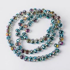 multicolored glass bead necklaces on white background