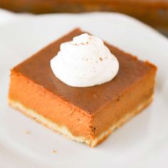 a piece of pumpkin pie with whipped cream on top