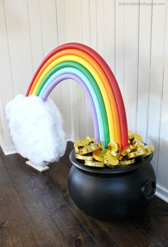 a pot full of gold next to a rainbow