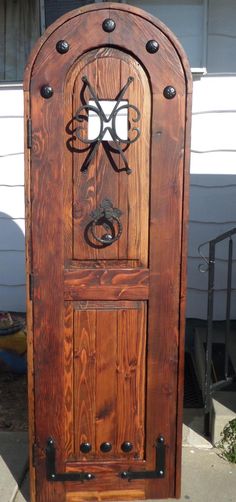 a wooden door with metal hardware on the front and side doors are made out of wood