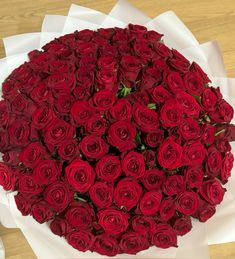 a large bouquet of red roses on a table