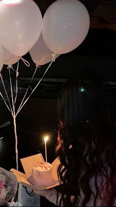 a woman is blowing out candles on her birthday cake