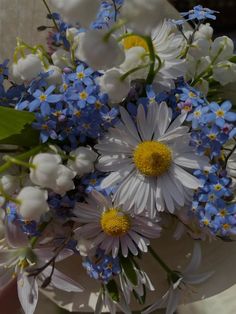 a bouquet of white, blue and yellow flowers