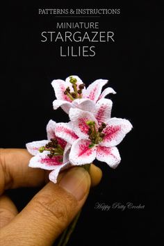 miniature stargazer lilies made with crochet and yarn are displayed in front of a black background