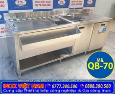 a stainless steel kitchen with two sinks and no faucets on the counter top