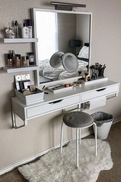 a white vanity with a mirror and stool in front of it on a carpeted floor