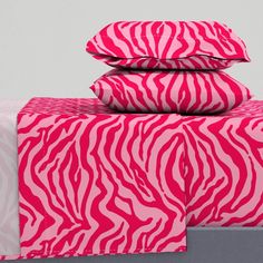 pink zebra print sheets and pillows on a bed