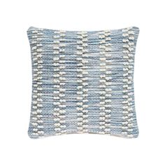 a blue and white pillow on a white background