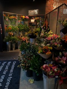 a bunch of flowers that are in buckets