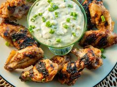 grilled chicken wings with ranch dip on a white plate