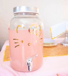 a pink cat water dispenser sitting on top of a table