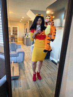 a woman in a winnie the pooh costume taking a selfie