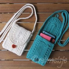 two crocheted purses sitting on top of a wooden table next to each other