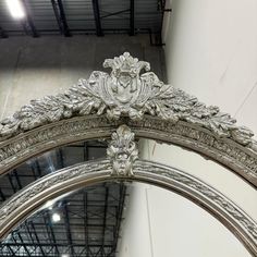 an ornate silver mirror hanging from the ceiling