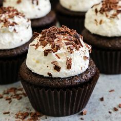 chocolate cupcakes with whipped cream and chocolate shavings