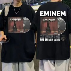 two young men standing next to each other wearing matching t - shirts with the same image on them