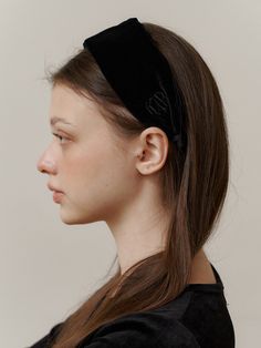 a woman wearing a black velvet headband