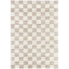 an area rug with squares on it in beige and white colors, including one square