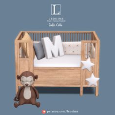 a stuffed monkey sitting next to a wooden crib with pillows on it's sides