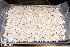 a pan filled with popcorn sitting on top of a stove