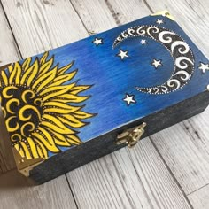 a painted box sitting on top of a wooden floor