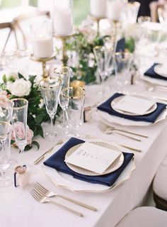 the table is set with blue and gold place settings