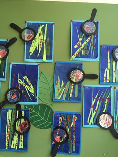 a group of children's artwork made with scissors and paper plates on a green wall