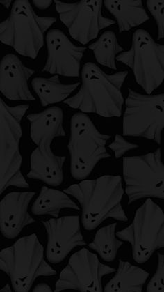 black and white image of many ghost heads in the dark, with one face partially hidden