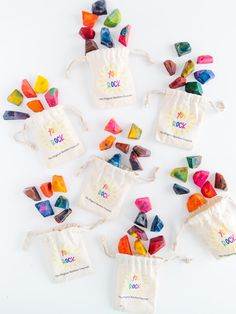 small bags filled with colorful candy on top of a white table