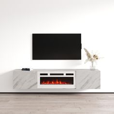 an entertainment center with a fireplace in the middle and a flat screen tv above it