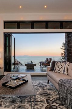 a living room filled with furniture and a large window