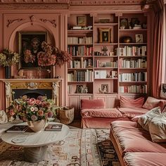 a living room filled with lots of furniture and bookshelves covered in pink walls