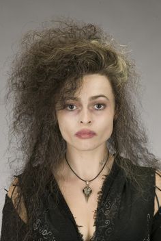 a woman with very long hair wearing a black shirt and choker on her neck