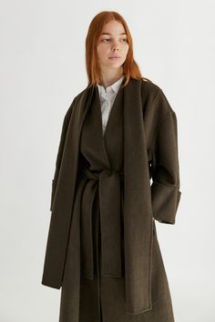 Information The Rhodes Coat is the outerwear piece that you have been looking for. It's a full-length coat featuring a back pleat detail, wide-cuffed sleeves, a waist belt and an included scarf that detaches at the back button. This elevated piece is a must for your closet staples collection. Details 50% Wool, 50% Polyester Oversized Fit Waist Belt Detachable Scarf Phoebe is 5'7" and wearing a size SMeasurements: 32" Bust, 25" WaistStyle #TM1858 Full Length Coat, Archive Fashion, Wrap Coat, Closet Staples, Rhodes, Cuff Sleeves, Black Coat, Waist Belt, Oversized Fits