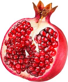 the pomegranate has been cut open to show it's seeds and leaves